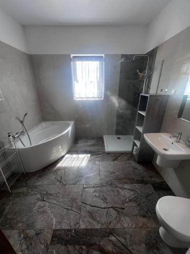a bathroom with a tub and a toilet and a sink at Unikatowy Dom 200 m2, Mielno, Pawłowo, Olsztynek in Mielno