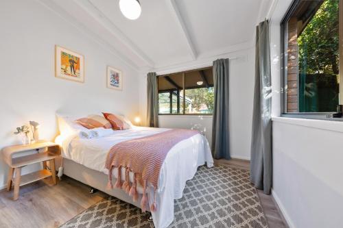 a bedroom with a bed and a window at Ashwood Alpine House in Bright