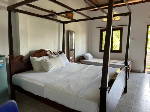 a bedroom with two beds in a room at Boomerang Una With Free Scooter Bike in Unawatuna