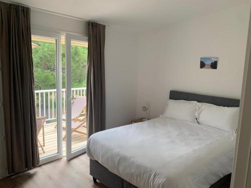 En eller flere senge i et værelse på Appartement en résidence privée