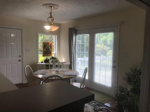 a dining room with a table and chairs and a window at Three Springs Plus in Lovingston