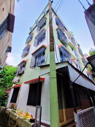 a building with windows and bars on it at Rest Inn Hotel Newtown Road Near Tata Medical in Kolkata