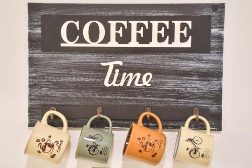 a group of key chains with the words coffee time at Your Cozy Hideaway in Skopje in Skopje
