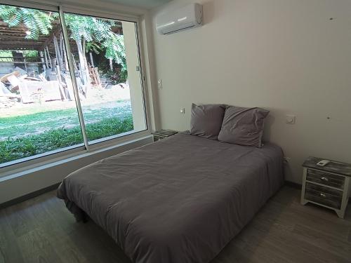 une chambre avec un lit et une grande fenêtre dans l'établissement Appart complet 3 chambres calme facture et repas possibles, à Beausemblant