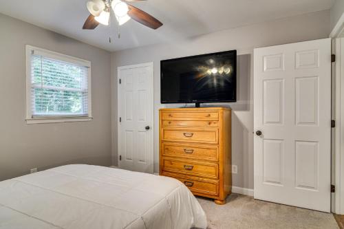 a bedroom with a bed and a tv on a dresser at Private Yard and Deck High Point Home Base! in High Point