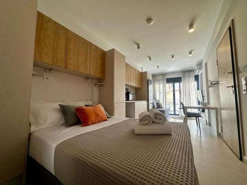 a bedroom with a bed with two towels on it at Alki-House in Athens
