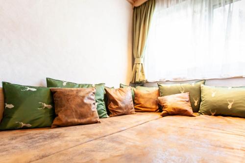 a group of pillows sitting on a couch in front of a window at Casa de Wisa in Gaschurn