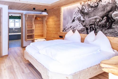 a bedroom with a bed and a picture of a deer at Casa de Wisa in Gaschurn