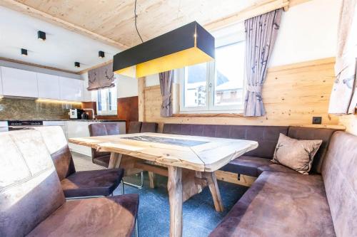 a dining room with a table and a couch at Casa de Wisa in Gaschurn