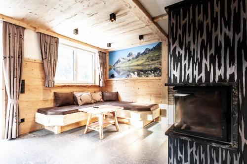 a living room with a couch and a fireplace at Casa de Wisa in Gaschurn