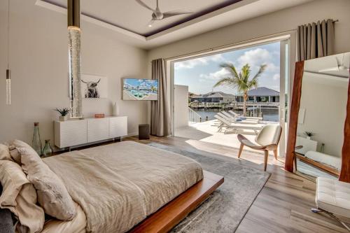 a bedroom with a large bed and a large window at Masterpiece by CoralVilla, high end, luxurious in Shell Point Village