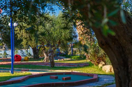 a park with a playground with a trampoline at Filoxenia Apartments & Studios in Theologos