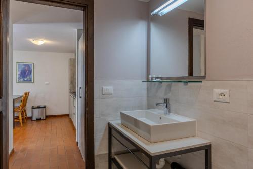 a bathroom with a white sink and a mirror at Residence San Michele in Costermano sul Garda