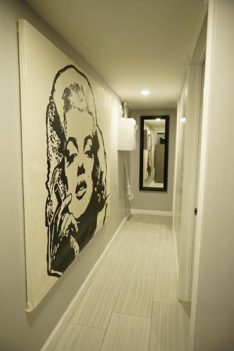 a hallway with a large black and white painting on the wall at Cozy 2 Bedroom In A Lovely Forest Hills Neighborhood in Parkside