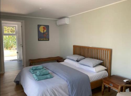 a bedroom with two beds with towels on them at Casa Jasmim in Sintra