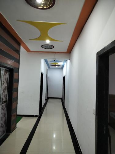 a corridor in a building with a ceiling at Ashirwad Hotel in Rīngas