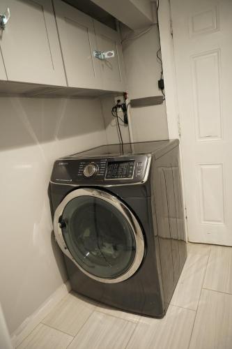 a washing machine in a corner of a room at Cozy 2 Bedroom In A Lovely Forest Hills Neighborhood in Parkside