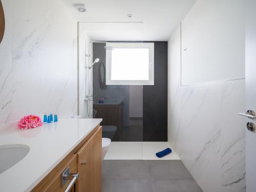 a bathroom with a sink and a toilet and a window at Amor a mar octopus in Puerto del Carmen
