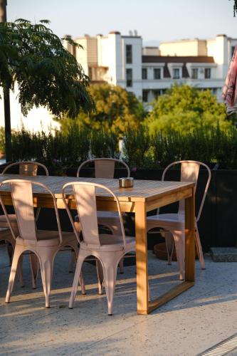 a wooden table with four chairs around it at Margot Sololaki in Tbilisi City