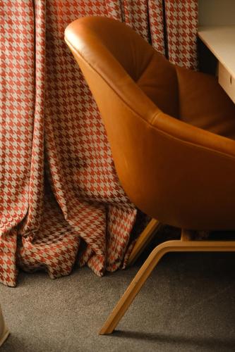 a chair sitting in front of a curtain at Margot Sololaki in Tbilisi City