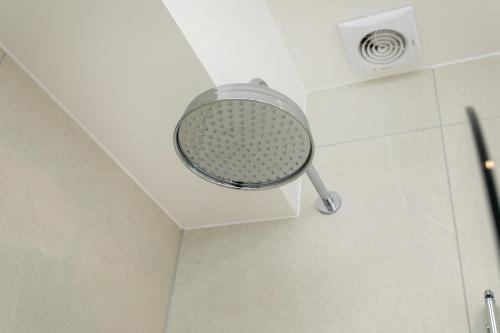 a shower head on the ceiling of a bathroom at Contractors,Parking,Wifi, SmartTV in Heeley