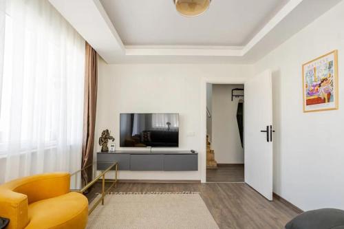 a living room with a television and a couch at Sorta Hotel in Antalya