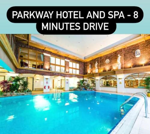 a hotel swimming pool with text overlay parkway hotel and spa minutes drive at Exec 2 bed lodge in rural Wales with Cymru Holidays in Pontnewydd