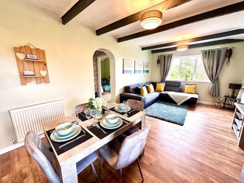 a living room with a table and a couch at Exec 2 bed lodge in rural Wales with Cymru Holidays in Pontnewydd