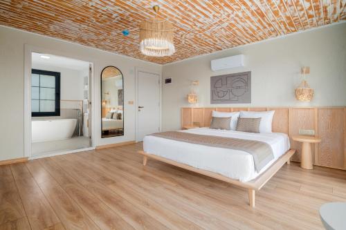 a bedroom with a bed and a bath tub at Baska Urla Otel in Denizli