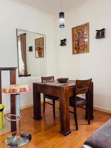 a dining room table with chairs and a mirror at Seaside Beach Bungalow in Dar es Salaam