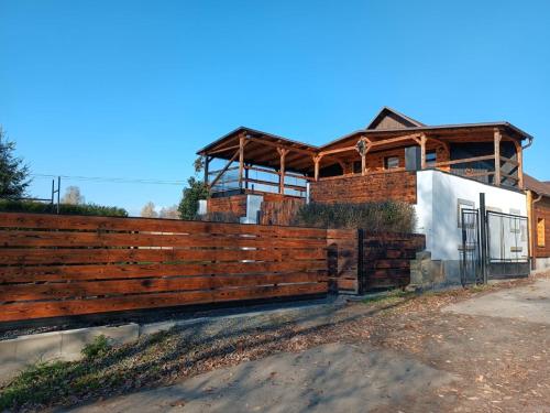 a wooden fence in front of a house at Chalupa Konírna in Rumburk