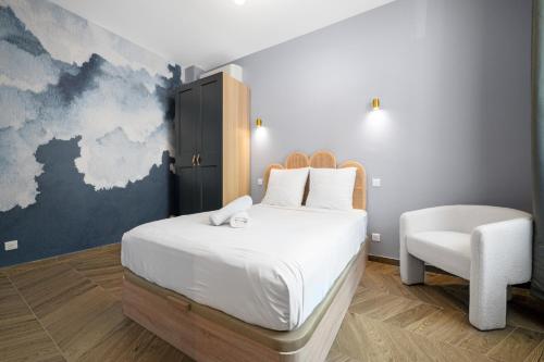 une chambre avec un lit blanc et une chaise dans l'établissement La Suite Lascaris PORT of NICE #renovated, à Nice