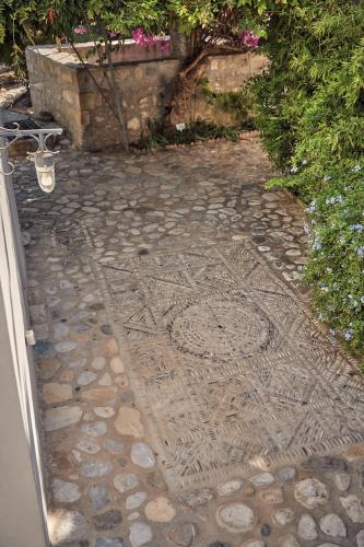 a stone walkway with a design on it at Muazzo Historic Residence, in the Village Core, By ThinkVilla in Pigi