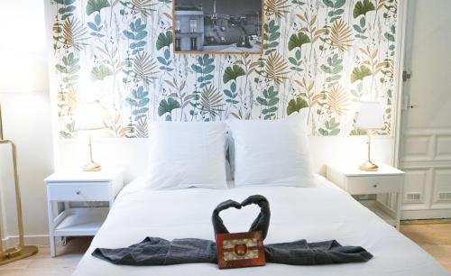 une chambre avec un lit avec un cygne noir dessus dans l'établissement Havre de paix - au cœur de Paris, à Paris