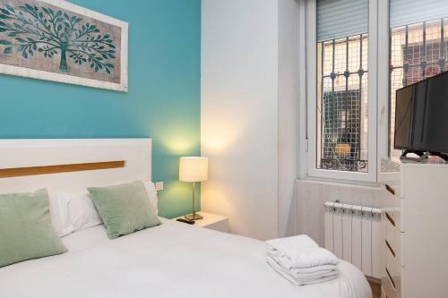 a bedroom with a white bed and a window at Modern and spacious-2Bedrooms 1Bathroom-Malasaña in Madrid