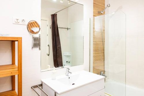 a bathroom with a sink and a mirror at Modern and spacious-2Bedrooms 1Bathroom-Malasaña in Madrid