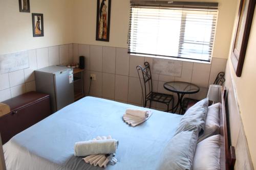 a hospital room with a bed and a window at Esperanca Guesthouse in Windhoek