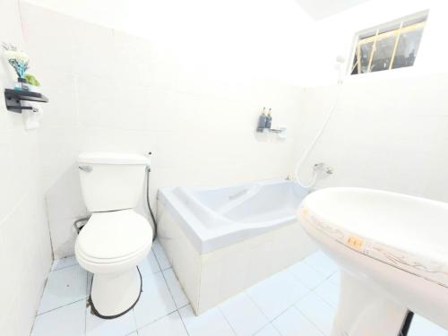 a white bathroom with a toilet and a sink at 3 Bed House - Sleeps 20 - Pets - Pool - Garden in Caba