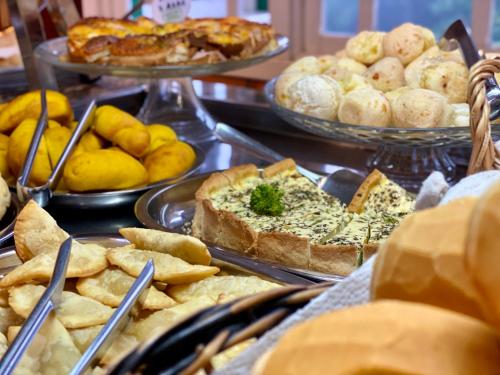 a table topped with lots of different types of food at Hotel Pousada Ald' Mama in Gramado