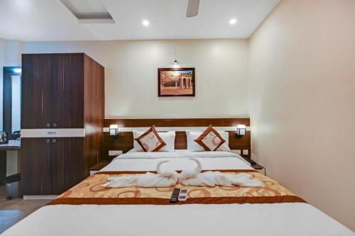 a bedroom with a large bed with towels on it at HOTEL SJ PRIDE in Bhubaneshwar