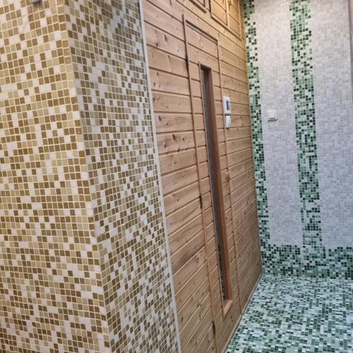 a bathroom with a walk in shower and a glass door at Belvárosi Pihenőház in Békéscsaba