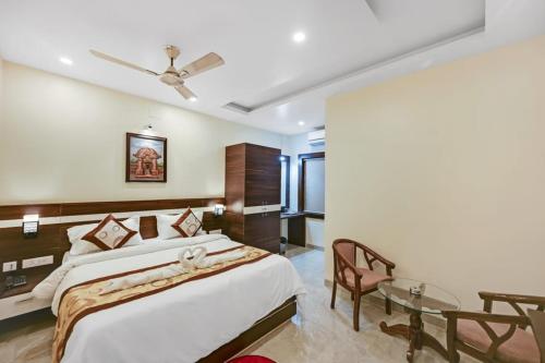 a bedroom with a large bed and a table at HOTEL SJ PRIDE in Bhubaneshwar
