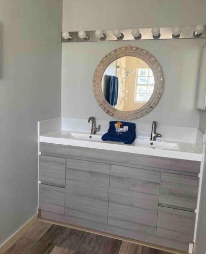 a bathroom with a sink and a mirror at Hollywood Townhouse steps to beach and famous Broadwalk in Hollywood Beach