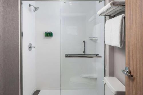a shower with a glass door in a bathroom at Sonesta Bee Cave Austin Hill Country in Bee Cave