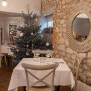 a table with a christmas tree in a room at The Crown Inn in Towcester