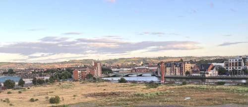 a view of a city with a bridge and a river at Belfast View Apartment in Belfast