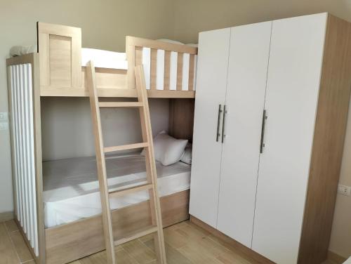 a small room with a bunk bed and a ladder at Relax at Celia Luxury 2 bedroom chalet at Azha in Ain Sokhna