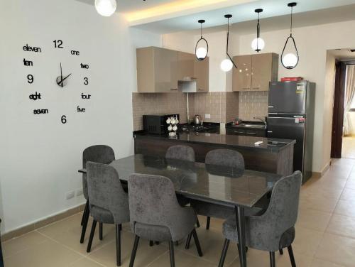 a kitchen with a dining room table and chairs at Relax at Celia Luxury 2 bedroom chalet at Azha in Ain Sokhna