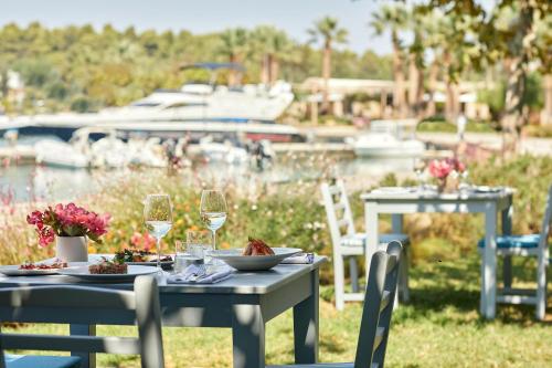 a table with plates of food and glasses of wine at Sani Club in Sani Beach