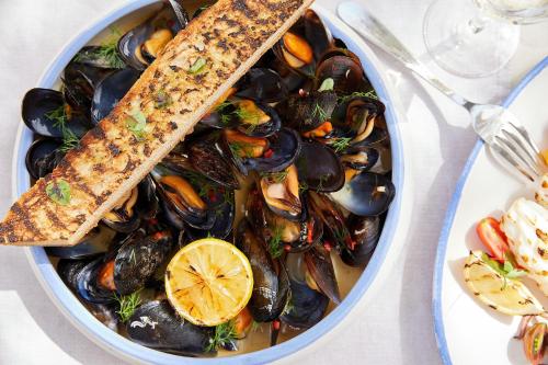 a bowl of mussels with a stick on top at Sani Club in Sani Beach